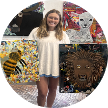 Annabelle Sulish holding up finished art pieces.