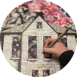 A hand doing finishing touches on house.